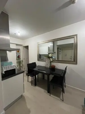 a kitchen and dining room with a table and chairs at Azure Condo Maui by arlene in Manila