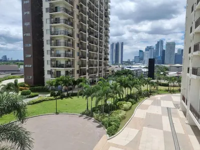 a view from the balcony of a building with palm trees at The Carly Suite in Manila