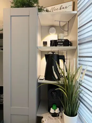 a shelf with a coffee maker and a plant at The Carly Suite in Manila