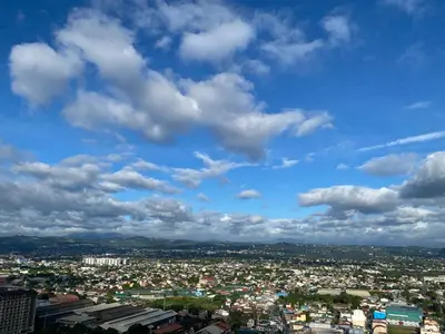 a view of a city under a cloudy sky at The Carly Suite in Manila