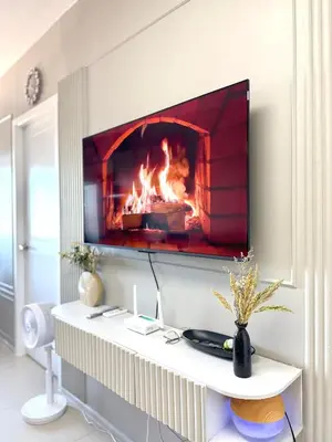 a fireplace in a living room with a fire place at The Carly Suite in Manila