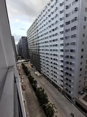 an aerial view of a large white building at Staycation Modern & Convenient in Tubigan