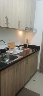 a kitchen with a sink and a counter top at Staycation Modern & Convenient in Tubigan