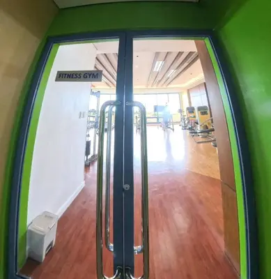 an entrance to a fitness gym with a glass door at 2BR Grand Riviera Suites by MrSayla in Manila