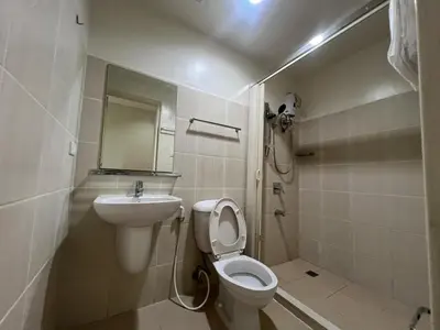 a bathroom with a toilet and a sink at 2BR Grand Riviera Suites by MrSayla in Manila