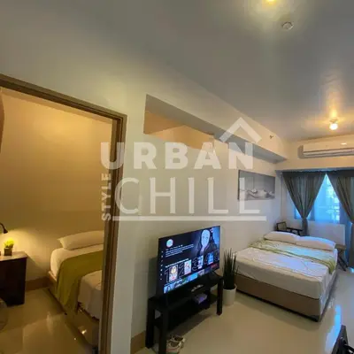 a bedroom with a bed and a flat screen tv at Urban Style Chill with Free Parking, Shore 3, MOA Complex Pasay, Manila in Manila