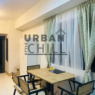 a dining room with a wooden table and chairs at Urban Style Chill with Free Parking, Shore 3, MOA Complex Pasay, Manila in Manila