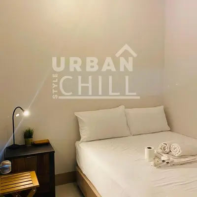 a bedroom with a bed with the words urban the chill on the wall at Urban Style Chill with Free Parking, Shore 3, MOA Complex Pasay, Manila in Manila