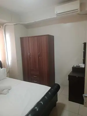 a bedroom with a bed and a wooden cabinet at 2bedroom with big balcony 1046D pool view in Manila