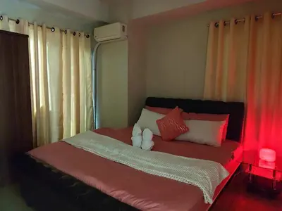 a bed with a teddy bear sitting on top of it at 2bedroom with big balcony 1046D pool view in Manila