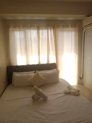 a white bed with a teddy bear on top of it at 2bedroom with big balcony 1046D pool view in Manila