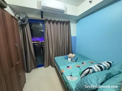 a bedroom with a bed with shells on it at Sea Residences by Laine in Manila