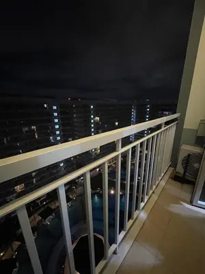 a view from the balcony of a building at night at 2bedroom with 2balcony with pool view 1633-34 in Manila