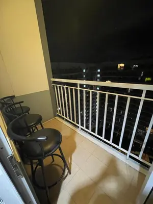 a balcony with chairs and a view of the city at 2bedroom with 2balcony with pool view 1633-34 in Manila