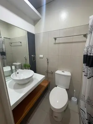 a bathroom with a white toilet and a sink at 2bedroom with 2balcony with pool view 1633-34 in Manila