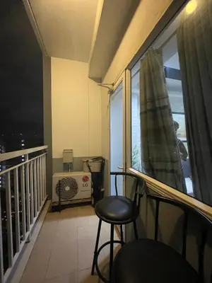 a balcony with a chair and a window at 2bedroom with 2balcony with pool view 1633-34 in Manila