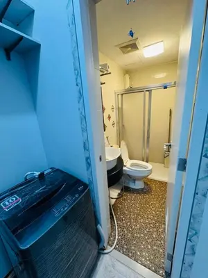 an open door to a bathroom with a toilet at Stamford Residences Fully-furnished in Manila