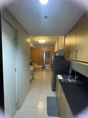 a kitchen with a sink and a counter top at 1bedroom pool view with big balcony in Manila