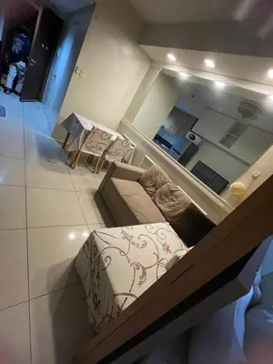 a room with a couch and a table and a mirror at 1bedroom pool view with big balcony in Manila