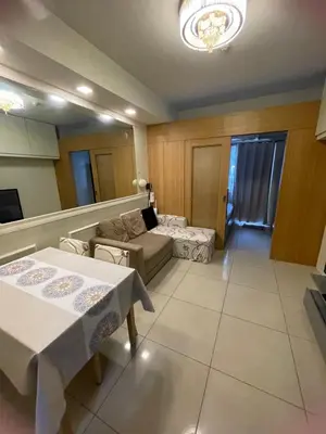 a living room with a couch and a table at 1bedroom pool view with big balcony in Manila