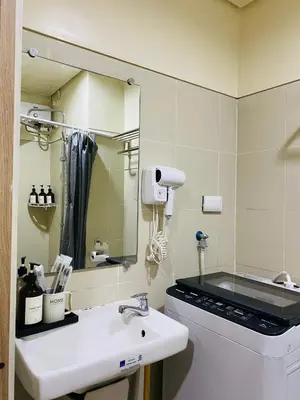 a bathroom with a sink and a mirror at Condotel at S Residences near SM MOA, SMX, Arena, NAIA Airport in Manila