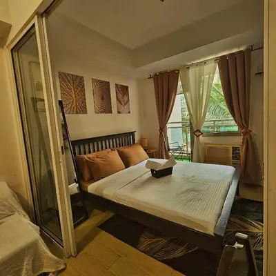 a small bedroom with a bed and a window at Azure Urban Resort Residences by Moldez Staycation in Manila