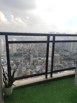 a view of a city from a window at Cozy Apartment City & Mountain View with balcony FREE use of pools sauna and sunbathing in Manila