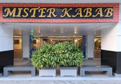 a mister kabab store with two plants in front of it at Unistay SHELL Residences Amazing Pool view near MOA in Manila