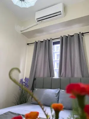 a living room with a couch and a window at Unistay SHORE 3 Tower 2 Pool View Cozy Suite in Manila