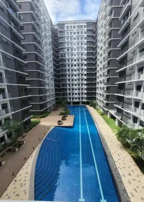an overhead view of a swimming pool between two tall buildings at Unistay SHORE 3 Tower 2 Pool View Cozy Suite in Manila
