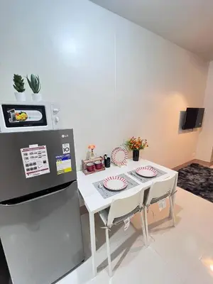 a kitchen with a table with two plates on it at Unistay SHORE 3 Pool view w Balcony near MOA in Manila