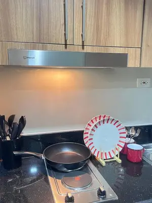 a stove top with a pan and a fan on it at Unistay SHORE 3 Pool view w Balcony near MOA in Manila