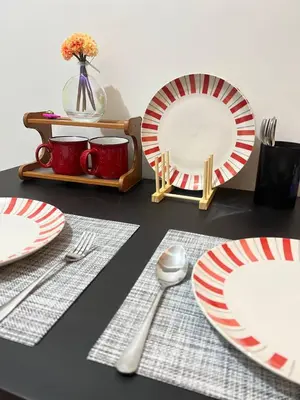 a table with red and white plates and silverware at Unistay SHORE 3 Tower 2 10th Floor w Balcony Pool View in Manila