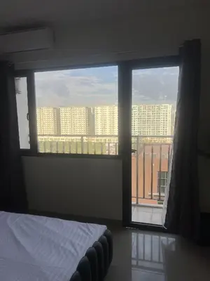 a bedroom with a window with a view of a city at Shore 2 Residences Executive Suite by JMS in Manila