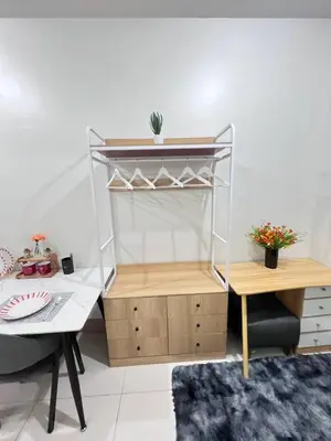 a room with a desk and a shelf and a table at Unistay SHORE 3 Poolview w Balcony in Manila