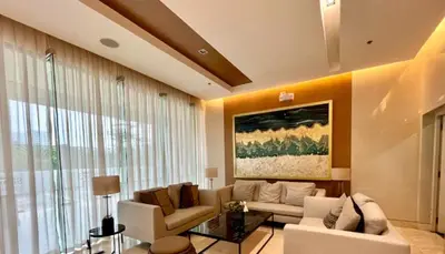 a living room with white furniture and a large window at Unistay SHORE 3 Poolview w Balcony in Manila