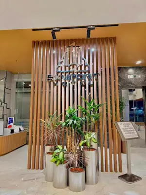 a lobby with plants in front of a building at Skyport Hotel in Manila