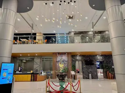 a lobby with a glass table in a building at Skyport Hotel in Manila