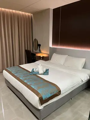 a bed with a stuffed animal sitting on top of it at Skyport Hotel in Manila