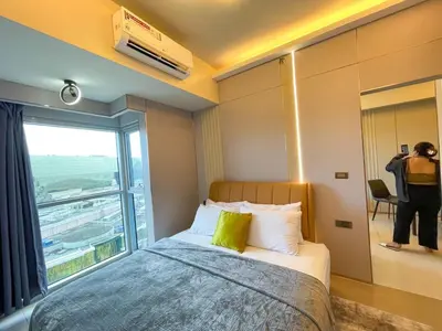 a bedroom with a bed and a large window at 1BR Executive Suite Beside Okada & Solaire - 4pax in Manila