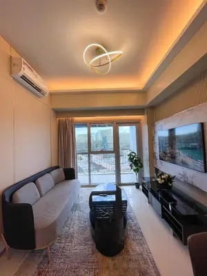 a living room with a couch and a tv at 1BR Executive Suite Beside Okada & Solaire - 4pax in Manila