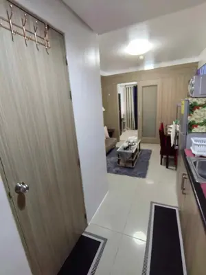 a door to a kitchen and a living room at Shore Residences in Manila