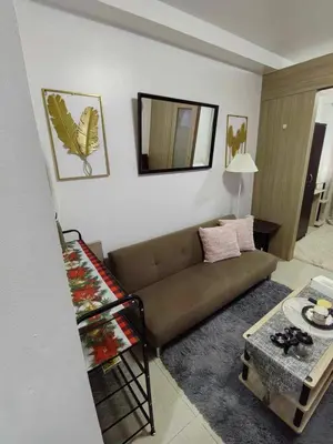 a living room with a couch and a table at Shore Residences in Manila