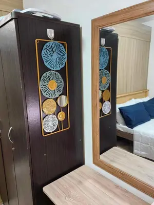 a mirror in front of a room with a bed at Shore Residences in Manila