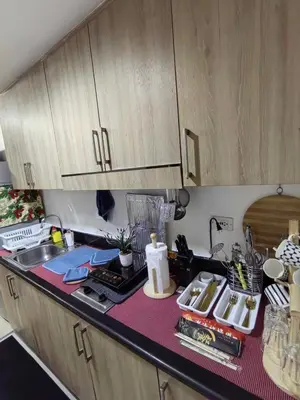 a kitchen with a sink and a counter top at Shore Residences in Manila
