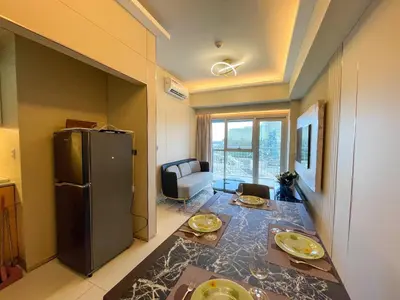 a kitchen with a refrigerator and a table with food on it at Spacious 1BR near Airport across Okada, Solaire in Manila