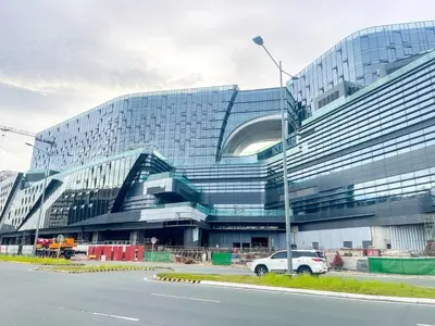 a large building with a car parked in front of it at Spacious 1BR near Airport across Okada, Solaire in Manila
