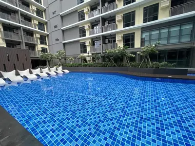 a large blue swimming pool in front of a building at Spacious 1BR near Airport across Okada, Solaire in Manila