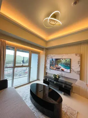 a living room with a couch and a table at Spacious 1BR near Airport across Okada, Solaire in Manila
