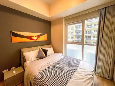 a bedroom with a bed and a large window at Spacious 2BR Luxury Suite across Okada, Airport in Manila